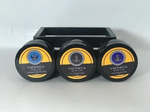 Three different flavors of valhalla shave soap in a black holder.