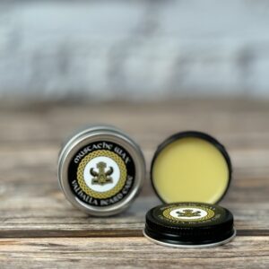 A close up of two containers of lip balm