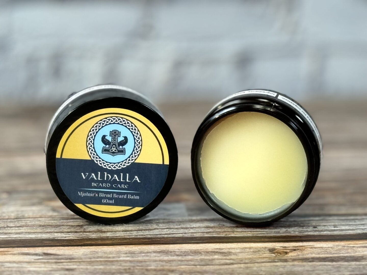 A couple of small containers with some kind of balm