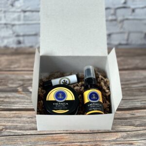 A box with two bottles of oil and a balm.