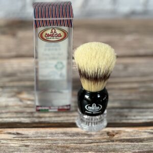 A shaving brush sitting on top of a wooden table.