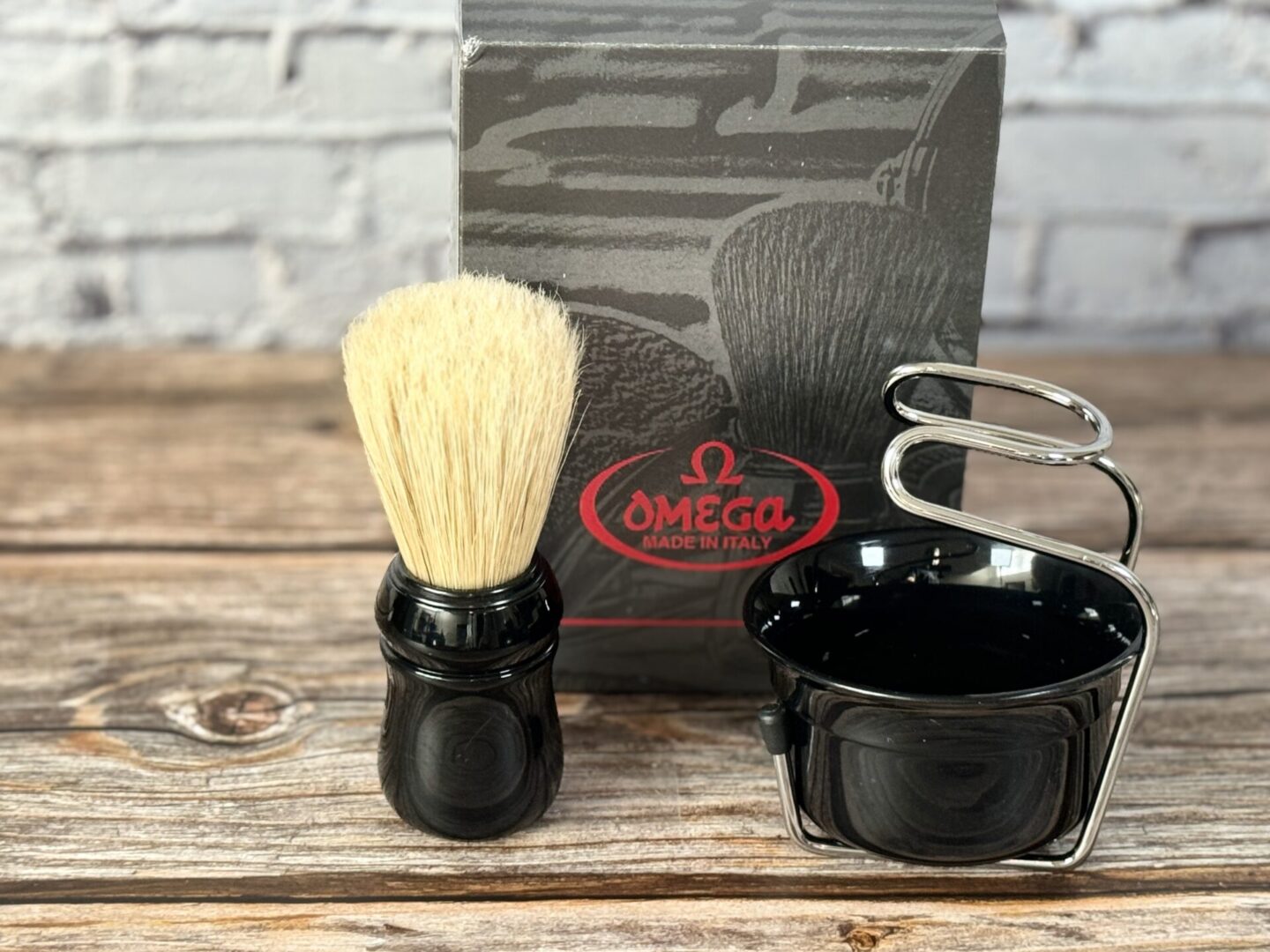A black shaving set with a brush and cup.