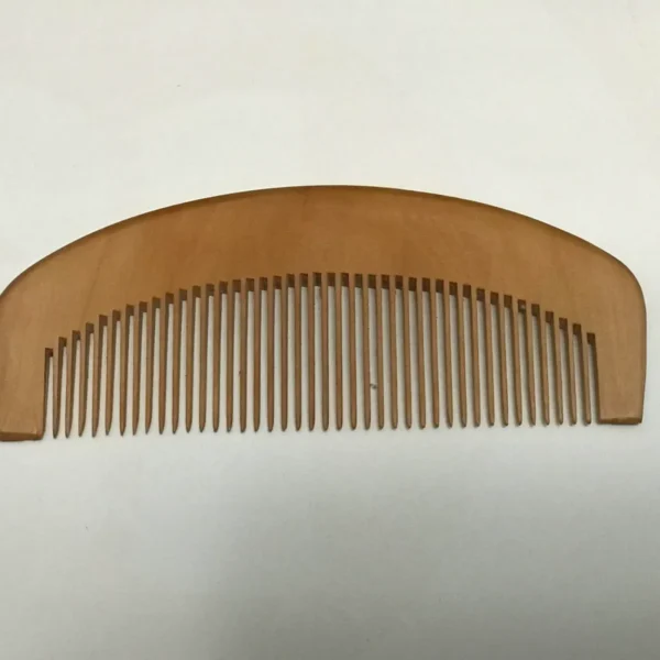 A wooden comb is shown on the wall.