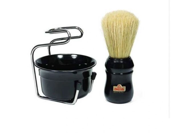 A black shaving brush and holder are next to each other.