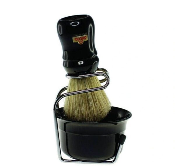 A black shaving brush sitting in a holder.