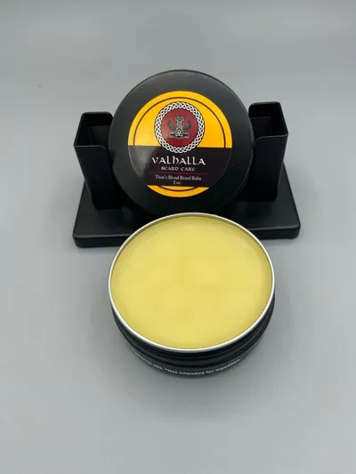 A yellow balm sitting on top of a black container.