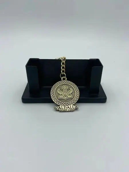 A gold medal sitting on top of a black stand.