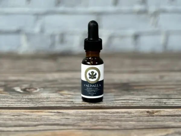 A bottle of cbd oil sitting on top of a wooden table.