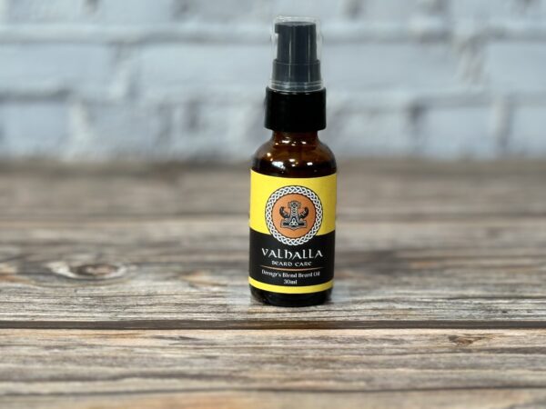 A bottle of essential oil sitting on top of a wooden table.