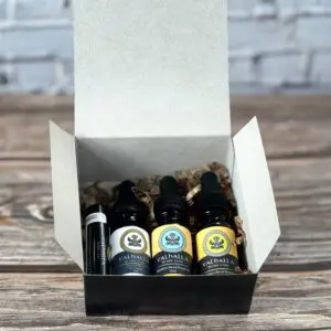 A box of four different oils sitting on top of a table.